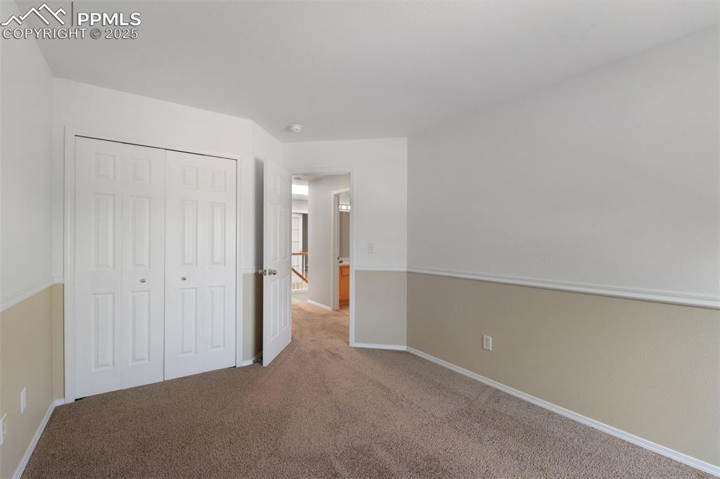 Image 25 of 37: Unfurnished bedroom with carpet floors and a closet