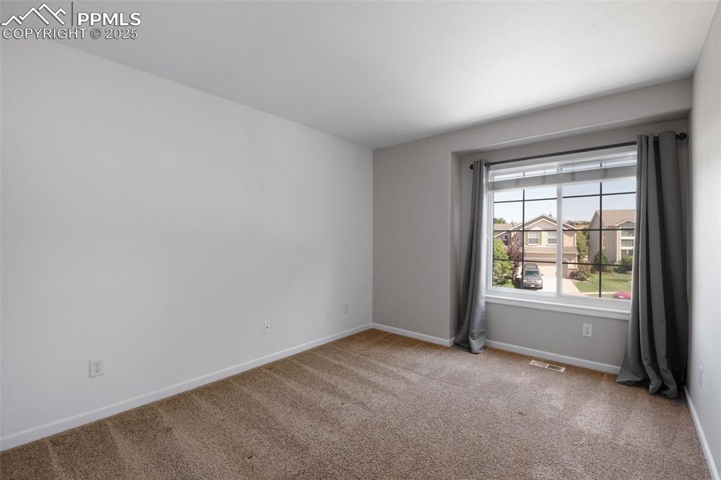 Image 26 of 37: Spare room featuring light colored carpet and baseboards