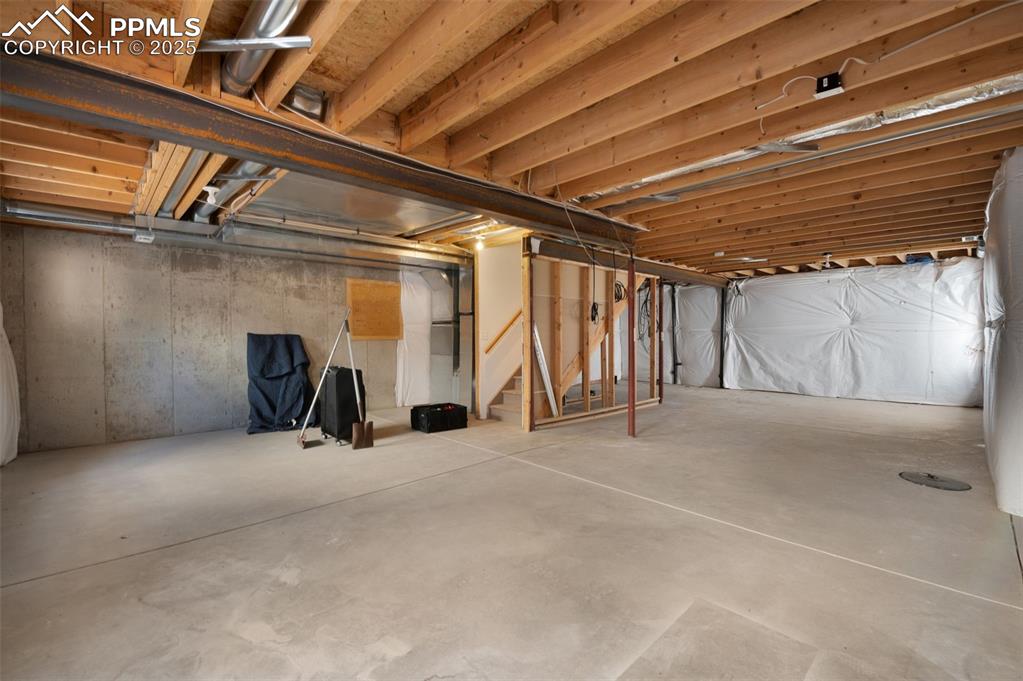 Image 29 of 37: Unfinished basement with stairs