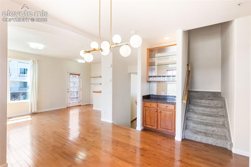 Image 8 of 34: Open to living room with dry bar