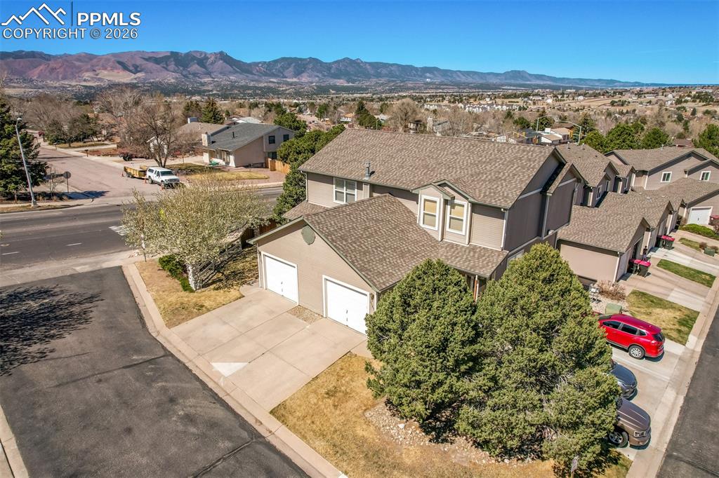 Image 24 of 30: Aerial view of residential area with mountains