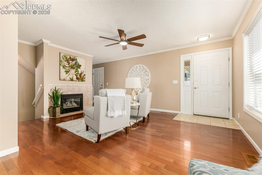 Image 4 of 30: Living room featuring a fireplace, hardwood / wood-style floors, a ceiling 