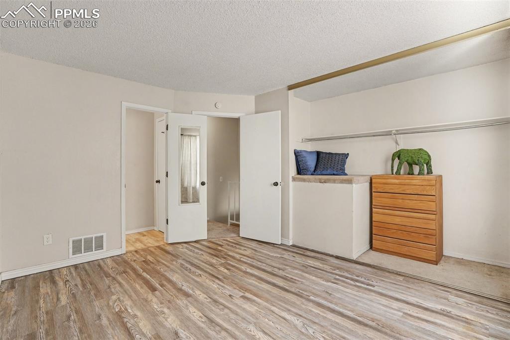 Image 13 of 25: Basement rec room has a closet and window and could be used as a 3rd bedroo
