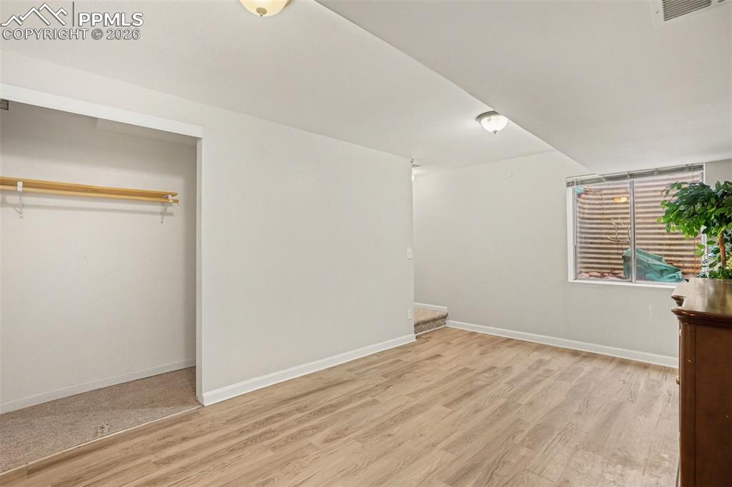 Image 14 of 25: Large versatile space in the basement for a family room, bedroom, office, e