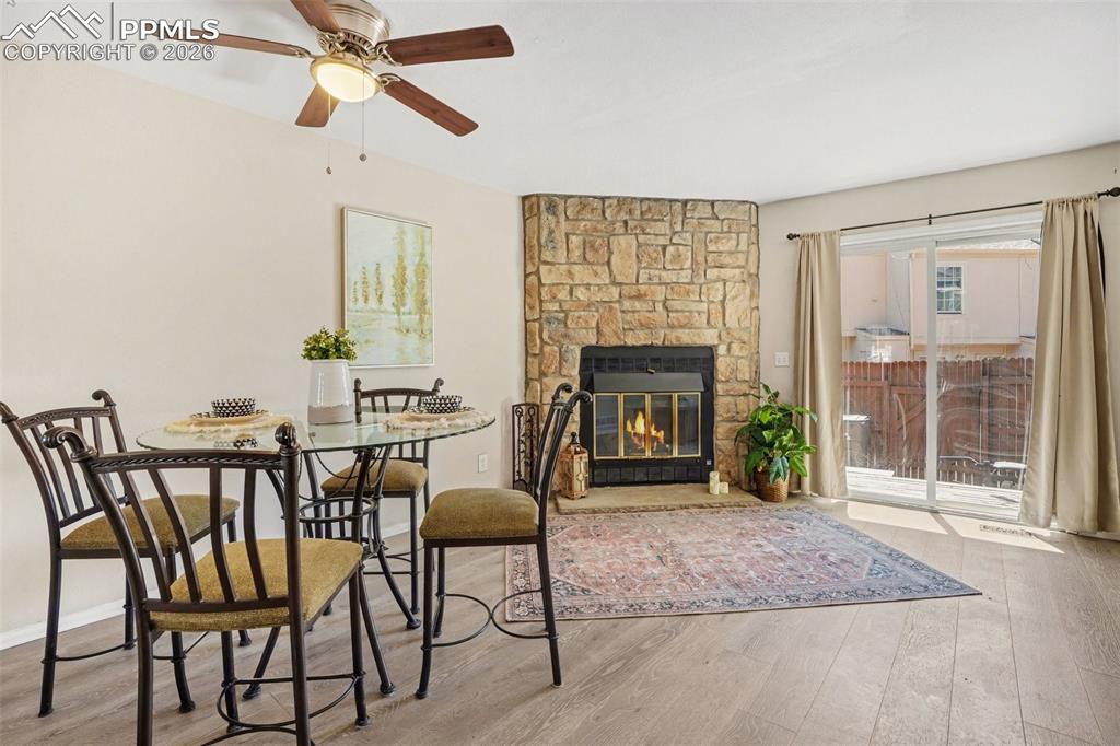 Image 3 of 25: Stone surround fireplace in living room and walk-out to back yard.