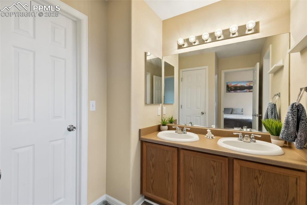 Image 17 of 29: Primary Bathroom w/ double sinks & large walk-in closet