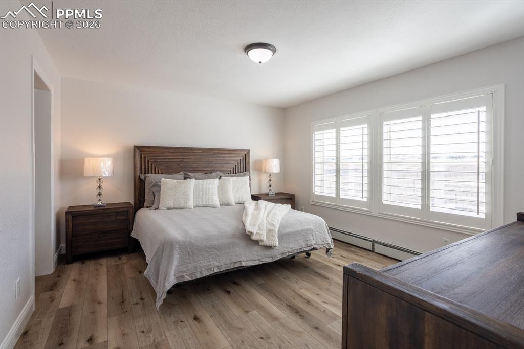 Image 16 of 50: Bedroom featuring vinyl plank flooring