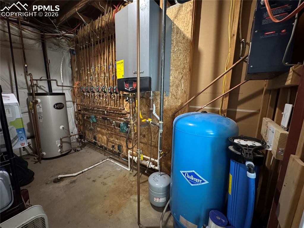 Image 44 of 50: Utility room, with boiler and hot water heater system, whole house filtrati