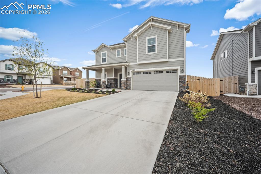 Image 2 of 45: Contemporary two-story residence with a covered front porch and stone accen