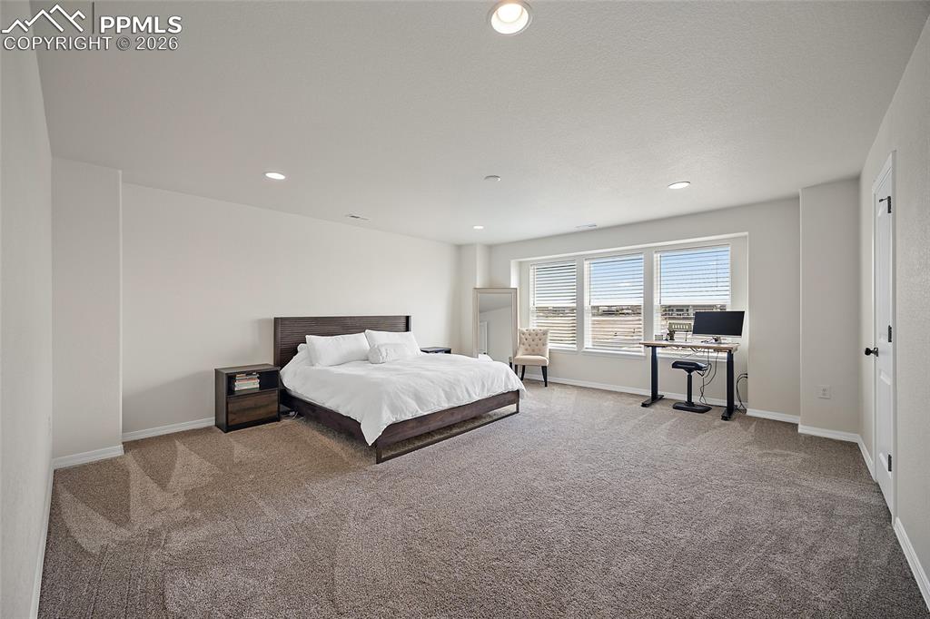 Image 24 of 45: Spacious room featuring neutral carpeting, recessed lighting, white walls, 