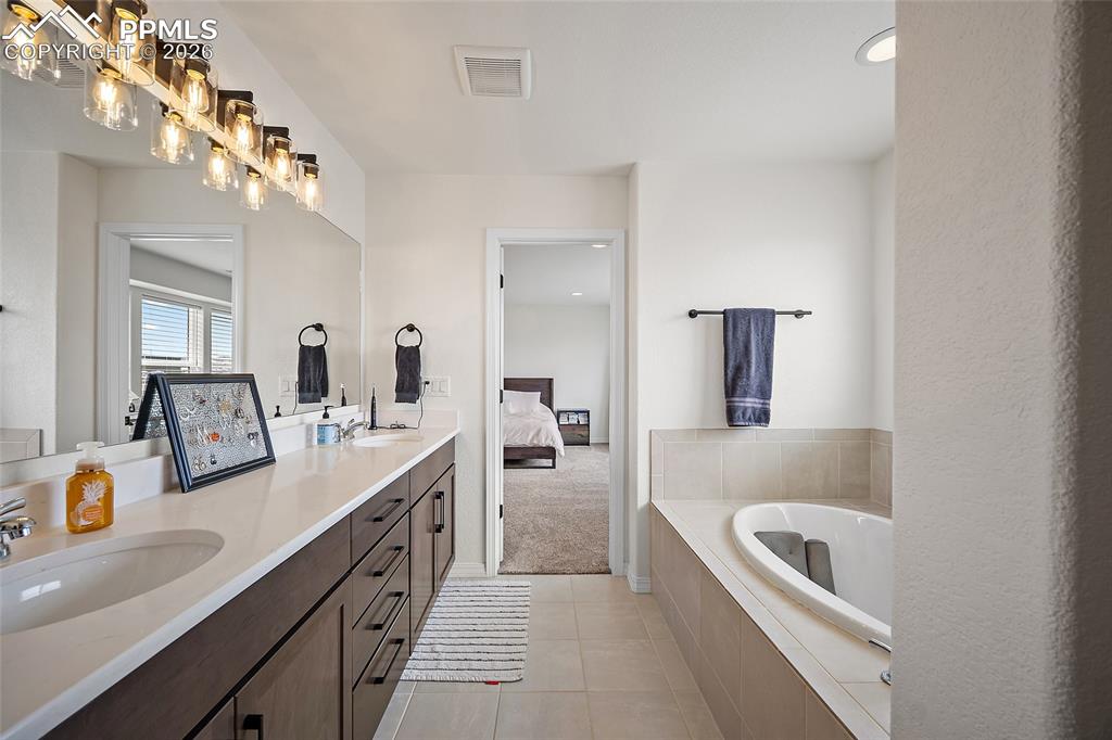 Image 30 of 45: Double vanity with undermount sinks and dark wood cabinetry