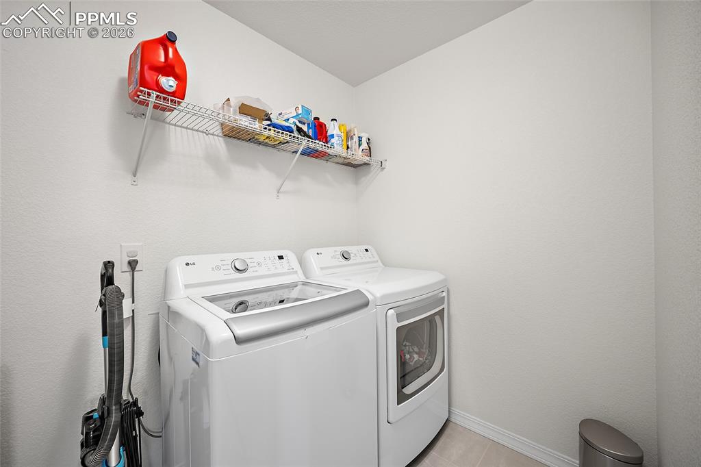 Image 32 of 45: Dedicated utility space featuring a washing machine and dryer