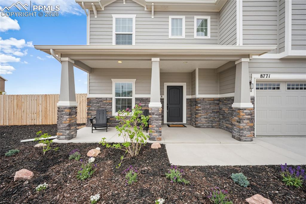 Image 4 of 45: Inviting front porch featuring stone accents and siding