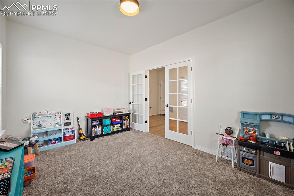 Image 7 of 45: Room featuring plush carpet flooring, white walls, and a contemporary flush