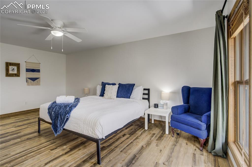Image 13 of 50: Bedroom featuring wood finished floors and ceiling fan