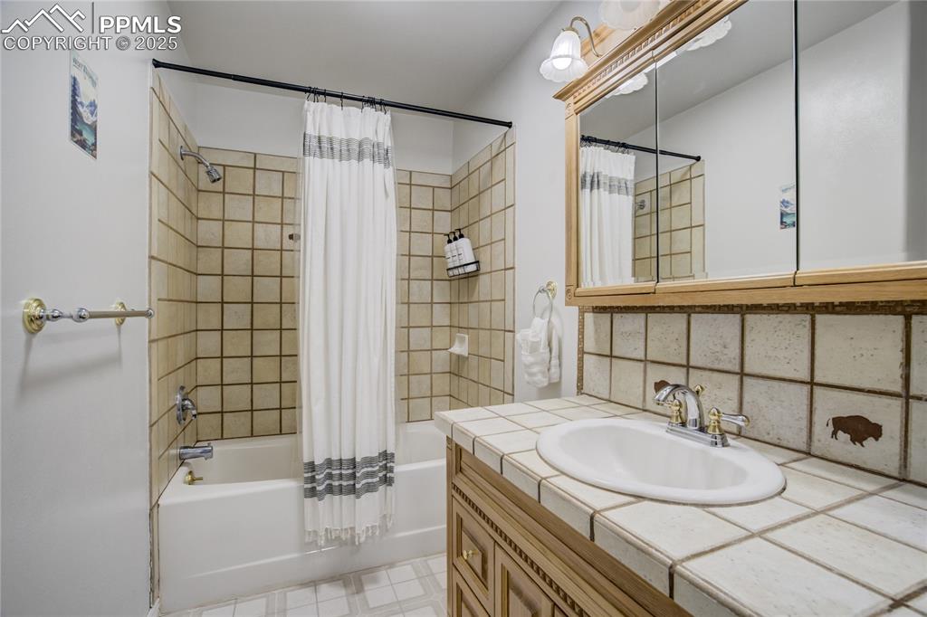 Image 15 of 50: Primary full bathroom featuring shower/bath combination with shower curtain
