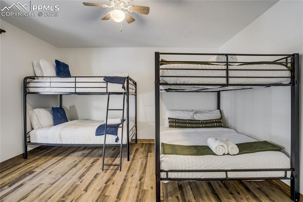Image 18 of 50: 3rd bedroom with LVP flooring and ceiling fan