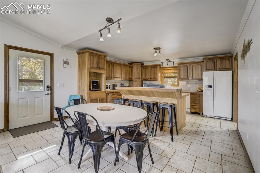 Image 3 of 50: Enter from the side door into the kitchen, dining area and family room.