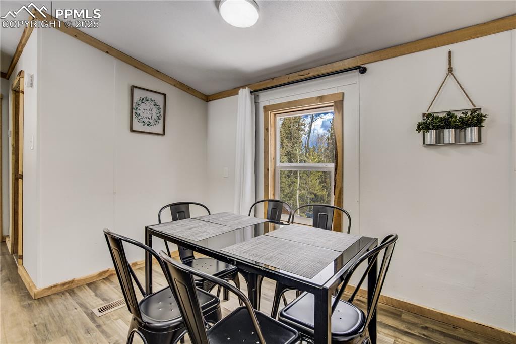 Image 31 of 50: 2nd home dining area, LVP floors with of the forest. 