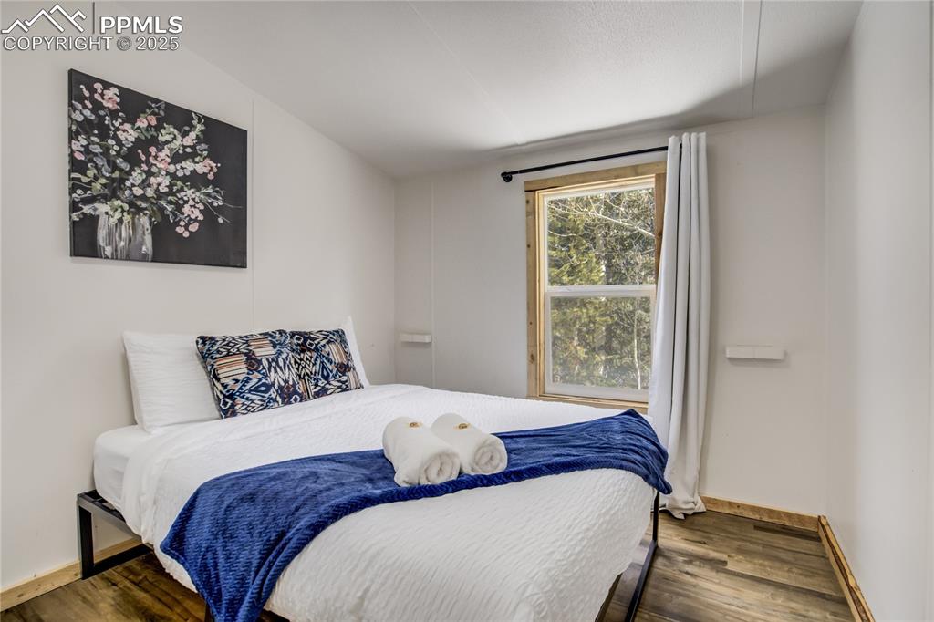 Image 38 of 50: 2nd home - 2nd bedroom, LVP floors and closet with vaulted ceiling.