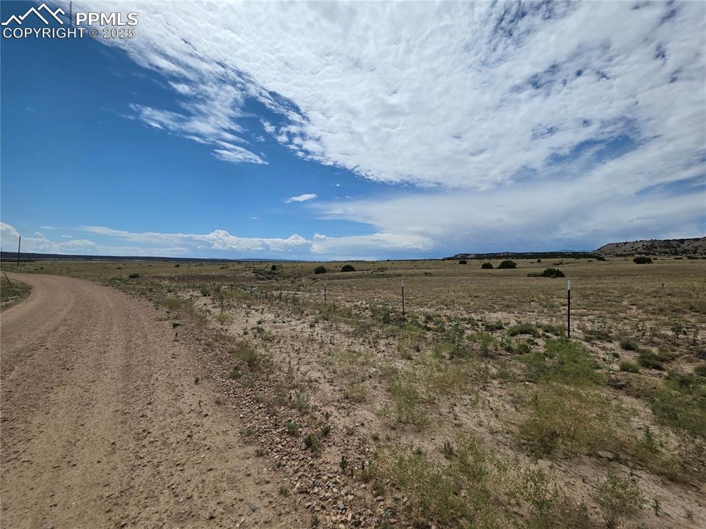 Image 9 of 9: View of dirt / gravel road with a rural view