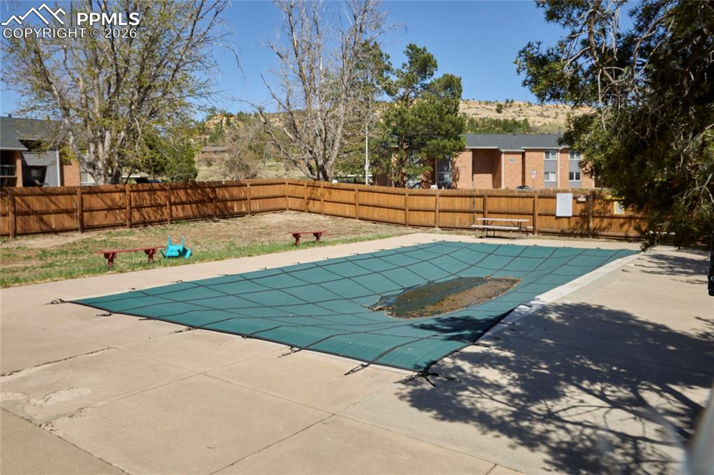 Image 23 of 28: View of swimming pool with a fenced in pool and patio area