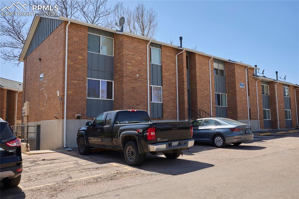 Image 25 of 28: View of property with uncovered parking