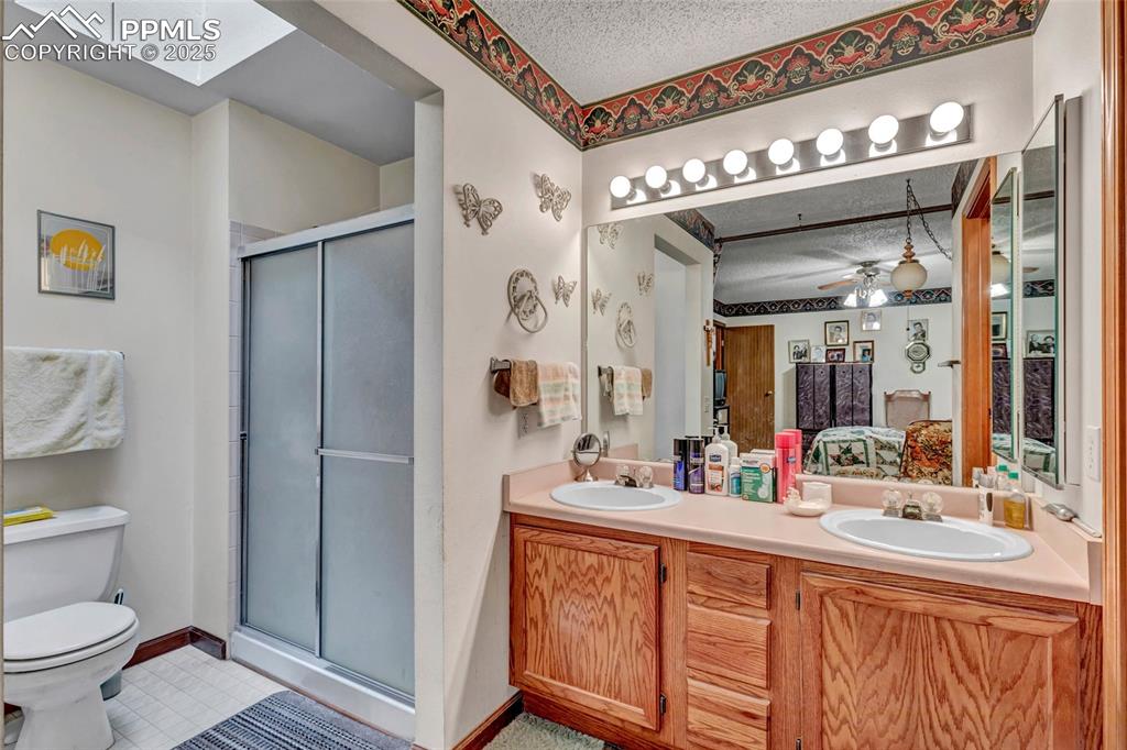 Image 14 of 21: Private ensuite bath with step-in shower.