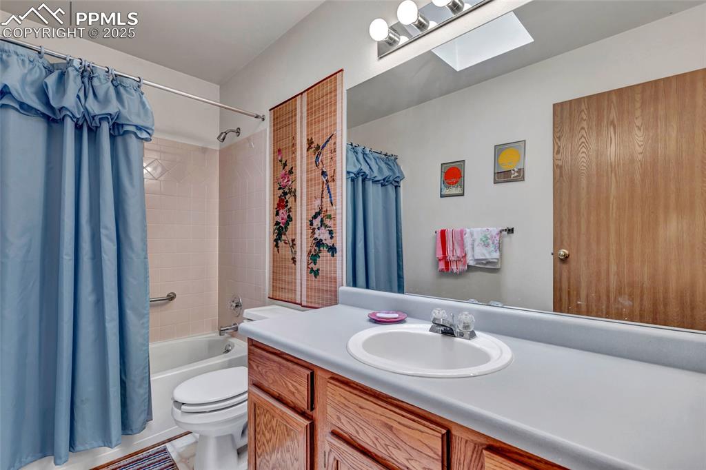 Image 17 of 21: Crisp and clean full bath with plenty of counter space and natural light fr