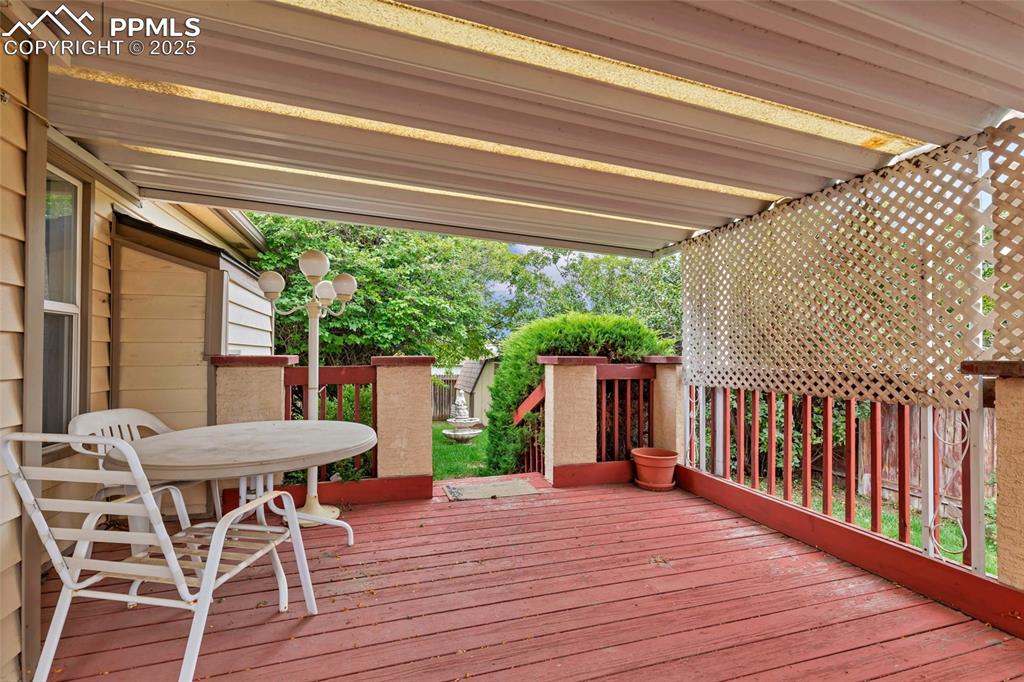 Image 18 of 21: Step outside and enjoy your morning coffee or evening unwind on this covere