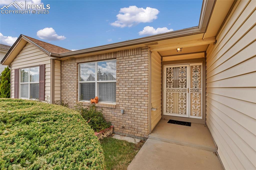 Image 2 of 21: Step inside through this cozy, covered entry — the perfect warm welcome eve