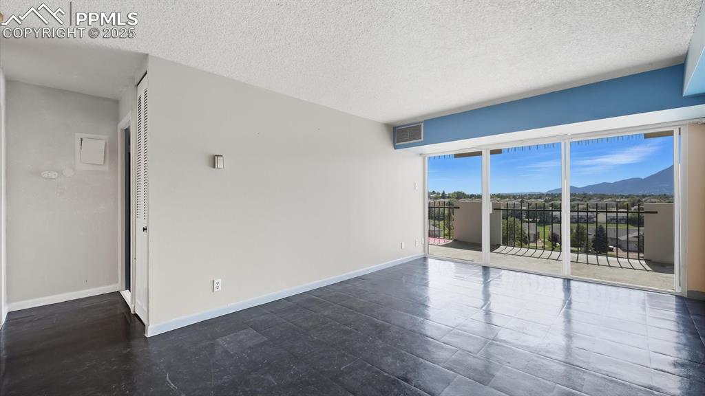 Image 10 of 31: Slider to an expansive balcony from the Living Room.