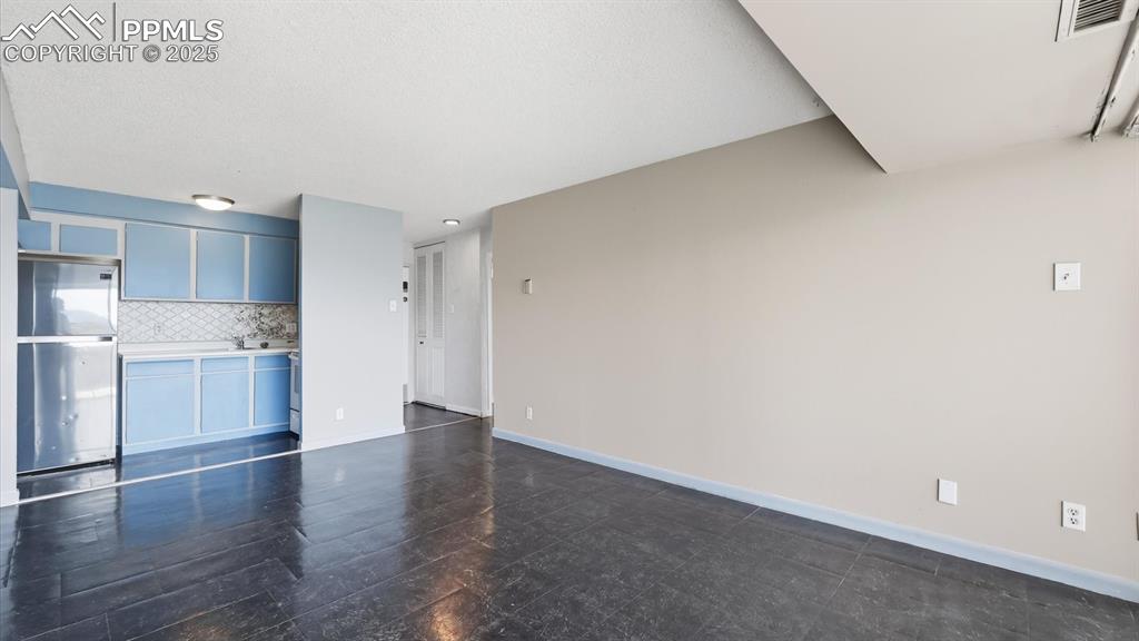 Image 12 of 31: The Living Room flows into the Galley Kitchen.
