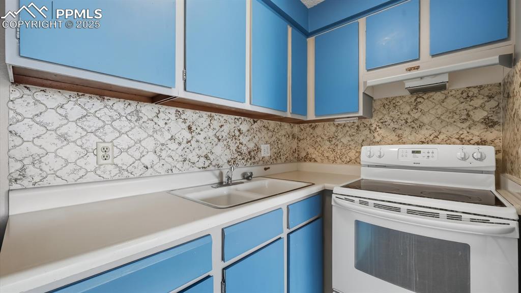 Image 13 of 31: Wood cabinets with laminate countertops.