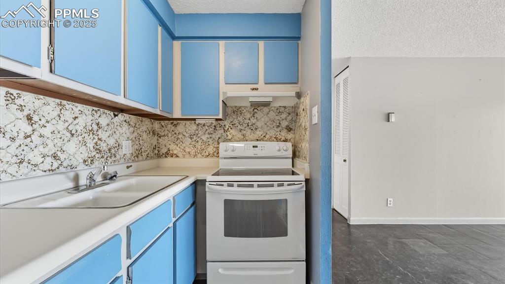 Image 15 of 31: Galley Kitchen off the Living Room.