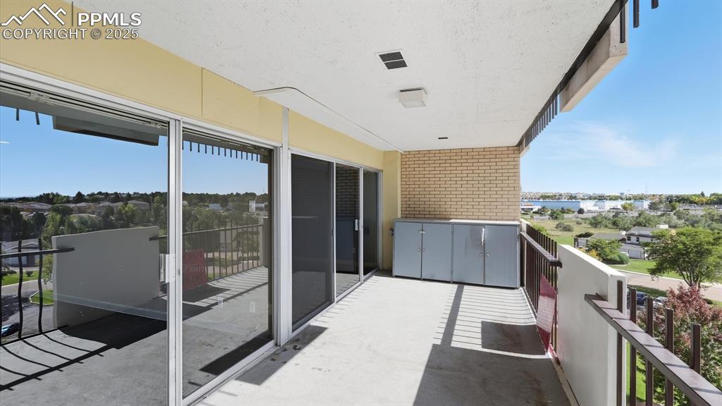 Image 24 of 31: Expanded balcony with locked cabinets for extra storage.