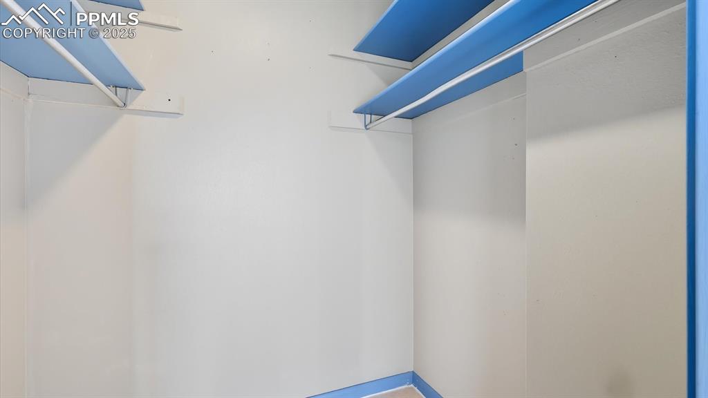 Image 27 of 31: Walk in closet in the Primary Bedroom.