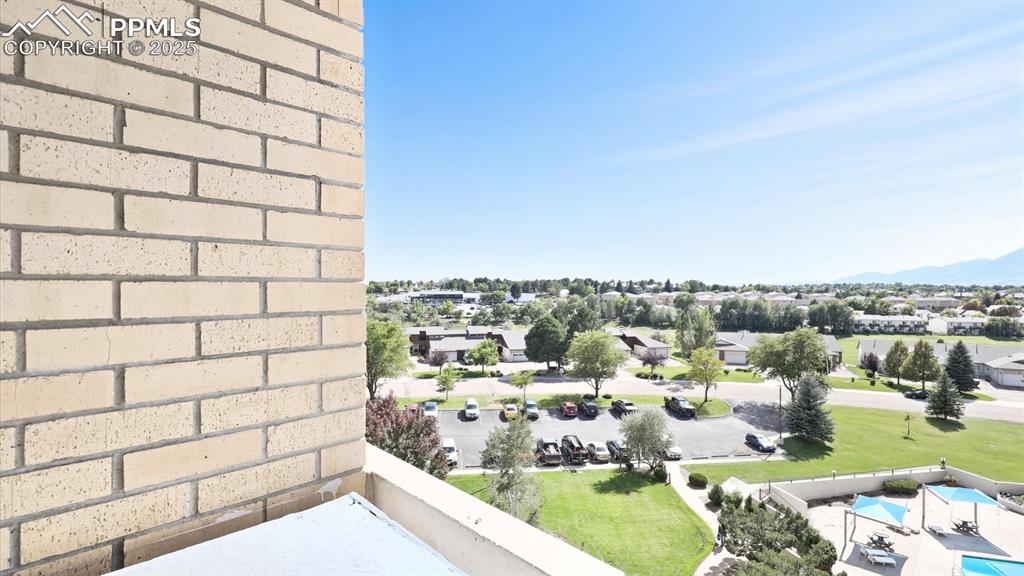 Image 29 of 31: Views of the pool, green space, and mountain views.