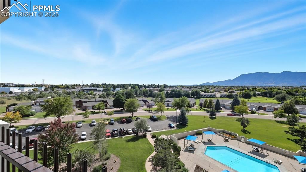 Image 30 of 31: Aerial views of the pool, green space, golf course, and mountains.