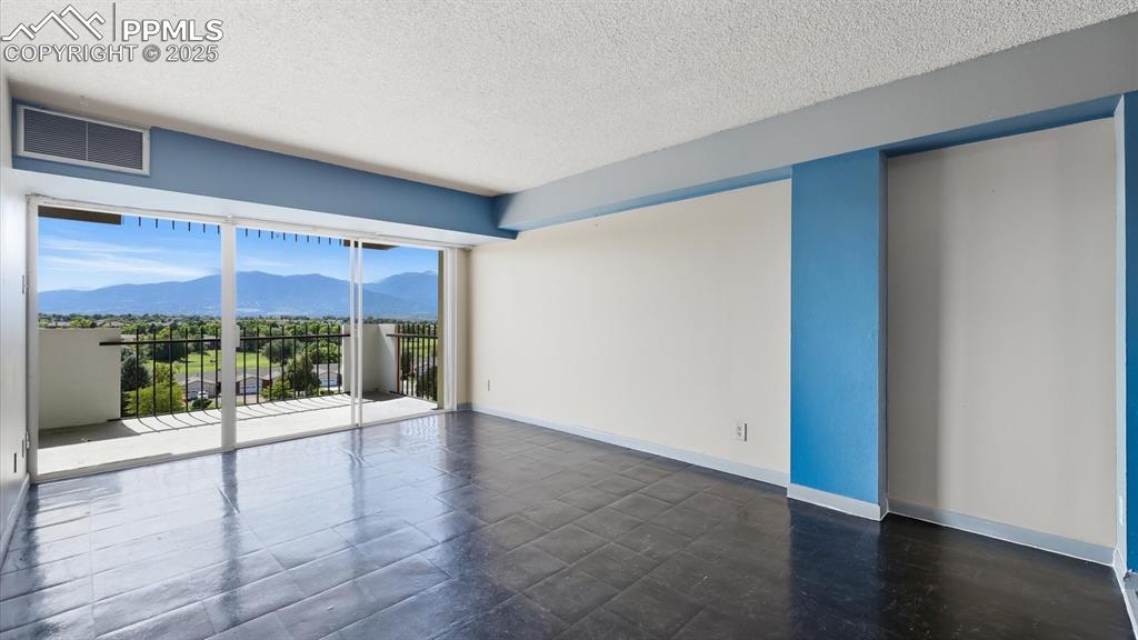 Image 8 of 31: Spacious Living Room with slider to an expansive balcony with incredible vi