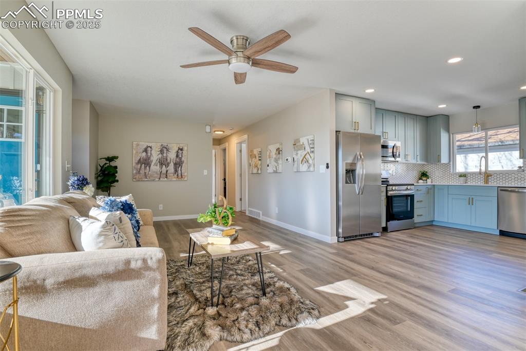 Image 19 of 48: Living room featuring light wood-style flooring, ceiling fan, and recessed 