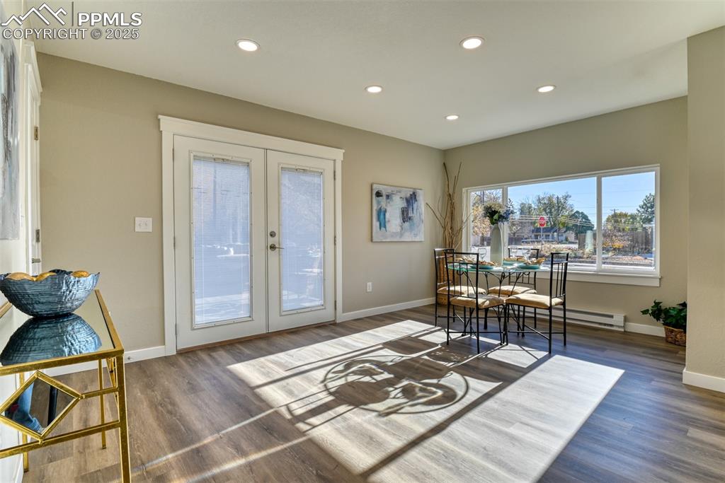 Image 25 of 48: Dining area featuring french doors, recessed lighting, dark wood finished f