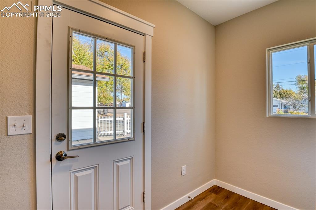 Image 30 of 48: Entryway featuring a textured wall, wood finished floors, and healthy amoun