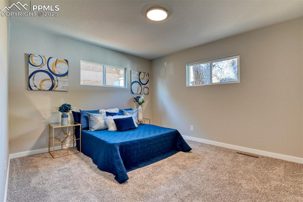Image 34 of 48: Carpeted bedroom with baseboards