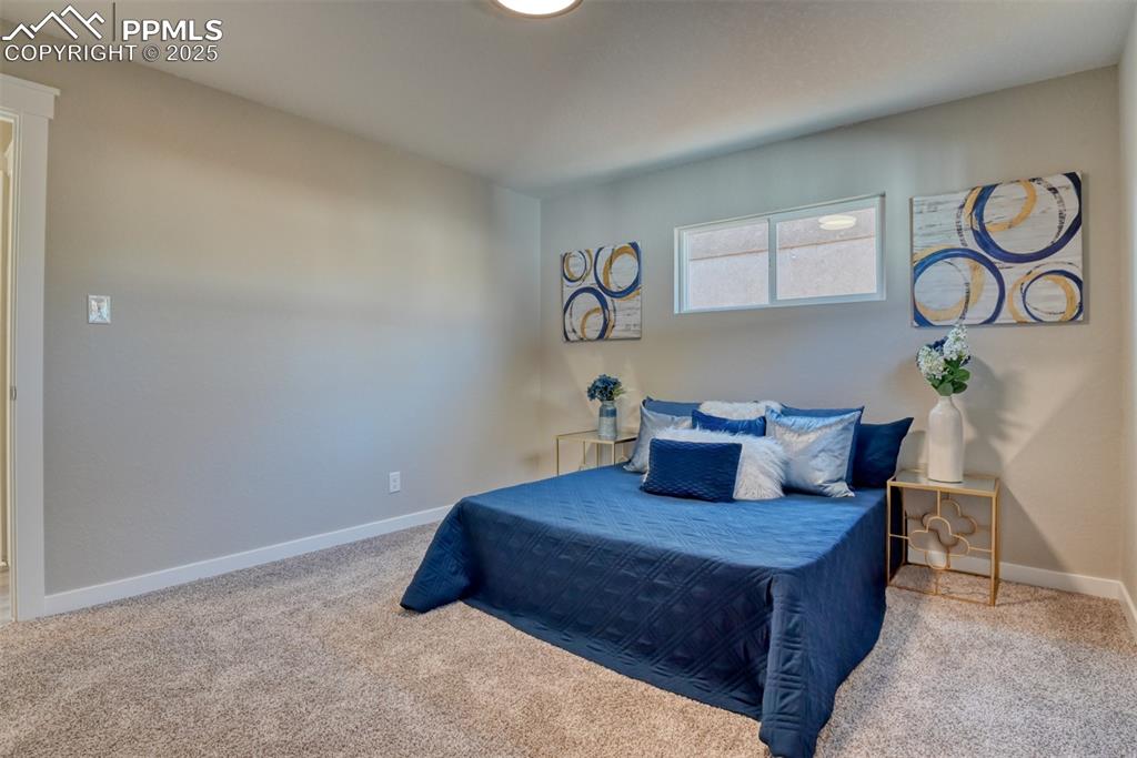 Image 35 of 48: Bedroom with carpet floors and baseboards