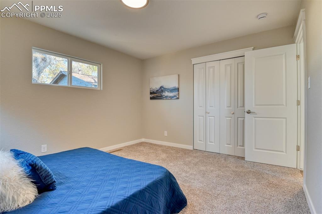 Image 37 of 48: Bedroom with light carpet and a closet