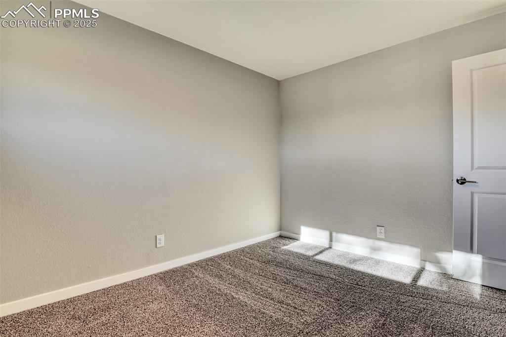 Image 41 of 48: Carpeted empty room featuring a textured wall