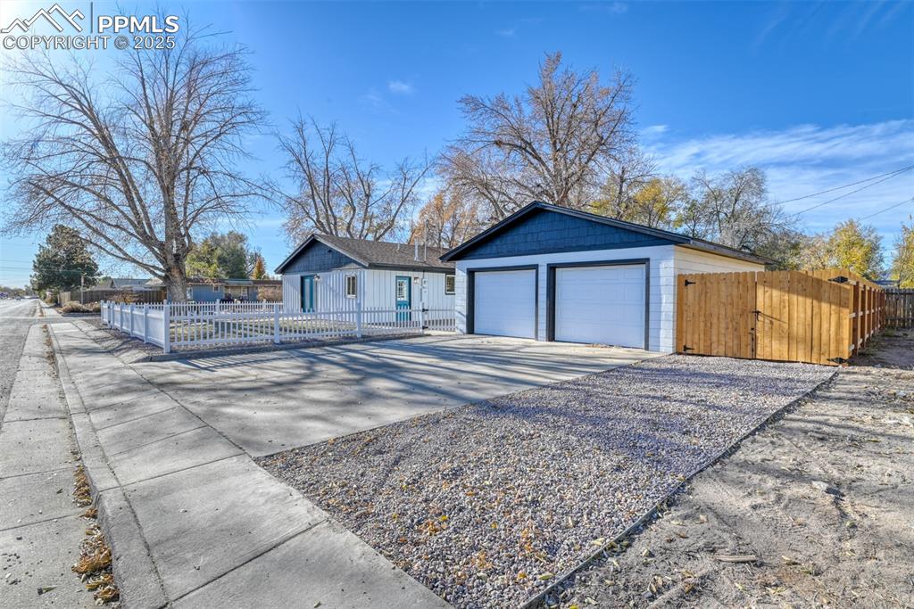 Image 6 of 48: Detached garage featuring a gate