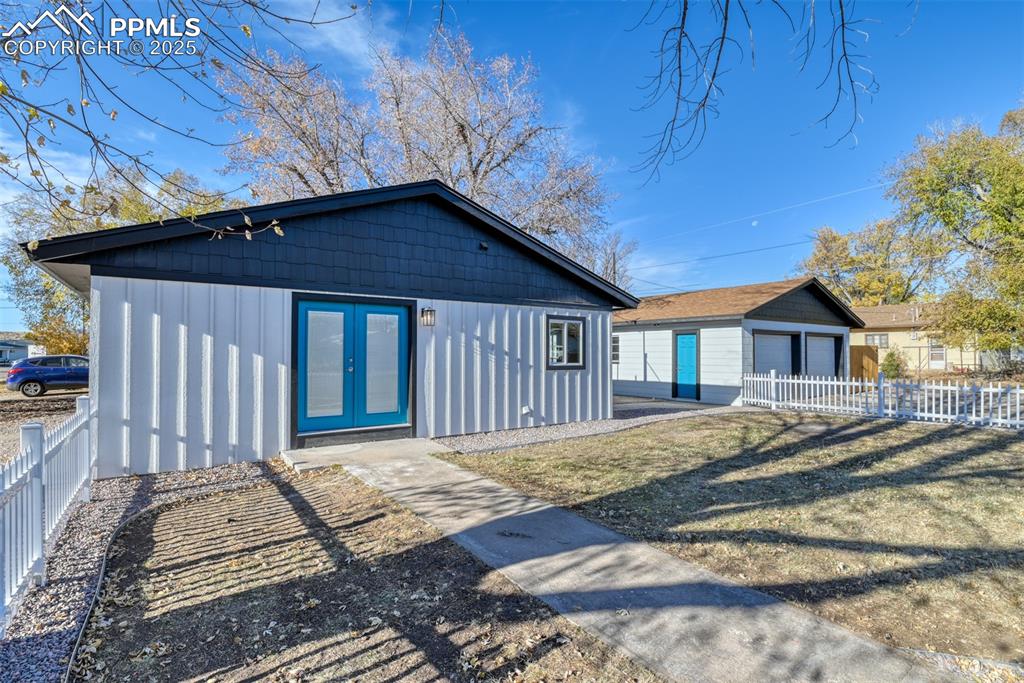 Image 9 of 48: Back of property with an outdoor structure and board and batten siding
