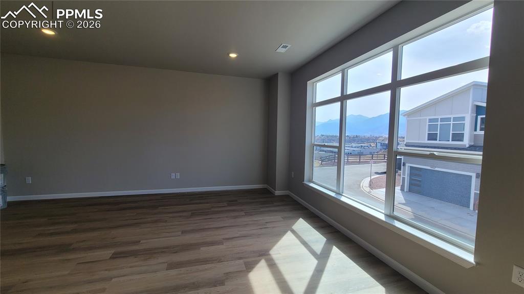 Image 9 of 26: Living Room in LVP flooring, LED lighting, walk out to deck, and an abundan